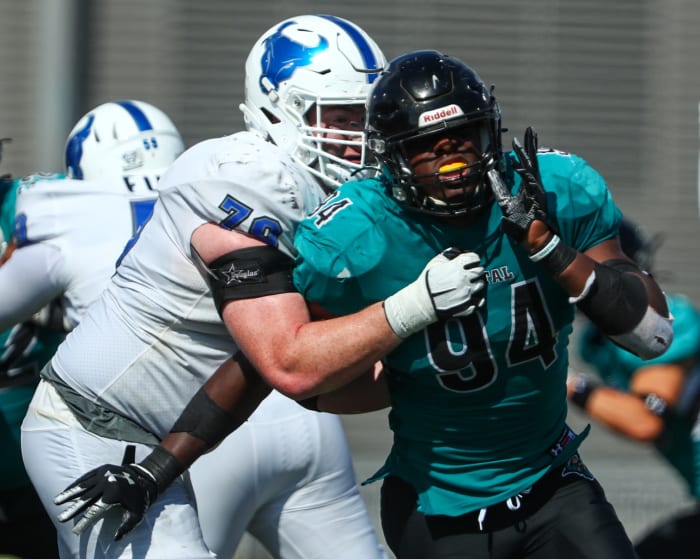Sep 18, 2021; Buffalo, New York, USA; Coastal Carolina Chanticleers linebacker Jeffrey Gunter (94) fights his way thru a block by Buffalo Bulls offensive lineman Nicholas Fronczak (76) during the fourth quarter of play at UB Stadium. Mandatory Credit: Nicholas LoVerde-USA TODAY Sports